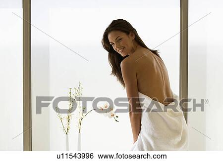 Stock Photograph - A young woman wrapped in a bath towel. Fotosearch