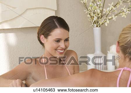Two young women in a bathroom View Large Photo Image Stock Image - Two young women in a bathroom. Fotosearch