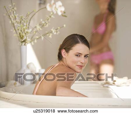 Stock Photo - Two young women in a bathroom. Fotosearch