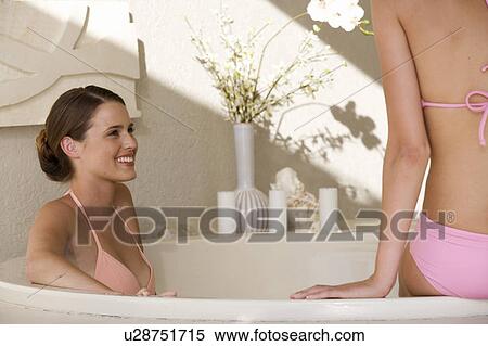 Stock Photography - Two young women in a bathroom. Fotosearch