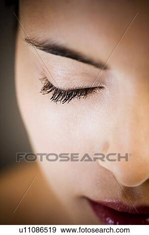 Detail of woman's face showing closed right eye View Large Photo Image Stock Photo - Detail of woman's face showing closed right eye. Fotosearch