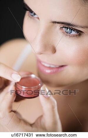 Woman applying lip gloss View Large Photo Image Stock Image - Woman applying lip gloss. Fotosearch