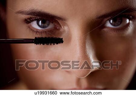 Woman applying mascara View Large Photo Image Stock Image - Woman applying mascara. Fotosearch