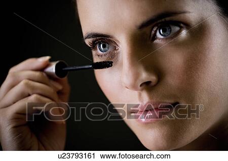 Stock Image - Woman applying mascara. Fotosearch