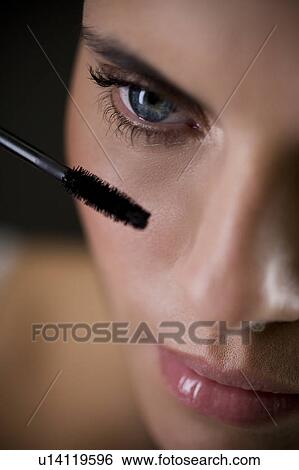 Woman applying mascara View Large Photo Image Stock Photograph - Woman applying mascara. Fotosearch