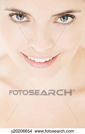 Picture - Close-up of young woman's face, smiling. Fotosearch