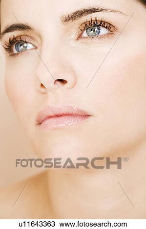 Stock Image - Portrait of a young woman, close-up of face. Fotosearch