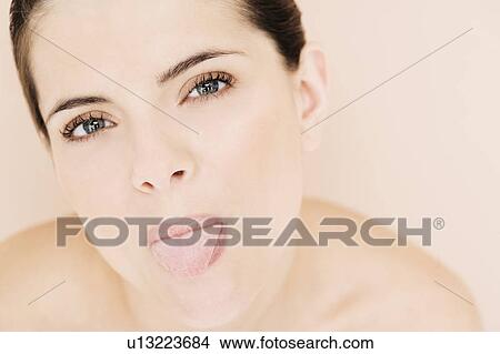 Portrait of young woman poking out her tongue View Large Photo Image Picture - Portrait of young woman poking out her tongue. Fotosearch