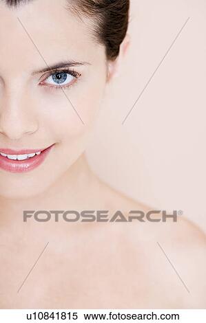 Stock Photography - Portrait of young woman showing left half of her face. Fotosearch