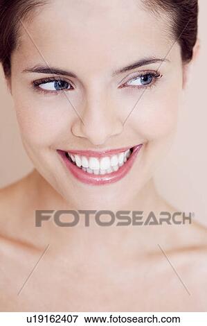 Stock Photo - Portrait of young woman smiling. Fotosearch