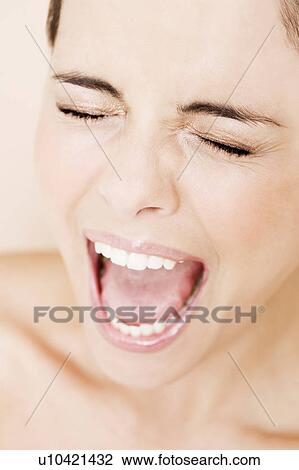 Portrait of young woman with eyes closed and mouth open wide, screaming View Large Photo Image Stock Image - Portrait of young woman with eyes closed and mouth open wide, screaming. Fotosearch