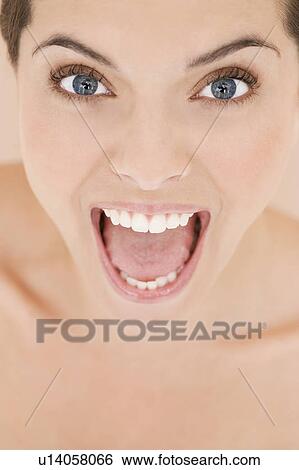 Portrait of young woman with mouth open wide, screaming View Large Photo Image Stock Photograph - Portrait of young woman with mouth open wide, screaming. Fotosearch