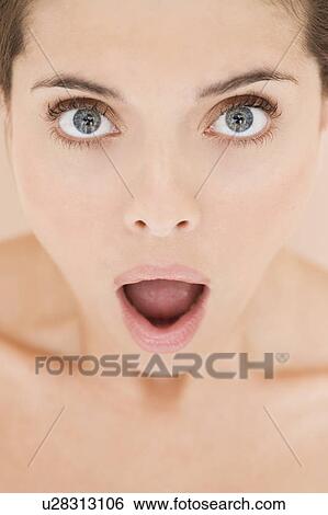 Portrait of young woman with mouth open in shock View Large Photo Image Stock Photograph - Portrait of young woman with mouth open in shock. Fotosearch