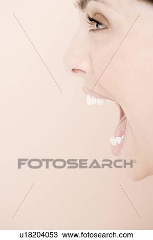 Profile of young woman with mouth open wide, shouting View Large Photo Image Stock Image - Profile of young woman with mouth open wide, shouting. Fotosearch