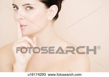 Woman putting her finger to her lips View Large Photo Image Stock Image - Woman putting her finger to her lips. Fotosearch