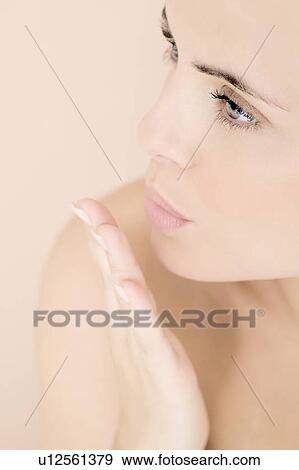 Young woman blowing a kiss, side view View Large Photo Image Stock Photo - Young woman blowing a kiss, side view. Fotosearch