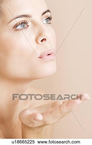 Young woman blowing a kiss View Large Photo Image Stock Photography - Young woman blowing a kiss. Fotosearch