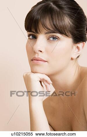 Stock Photography - Young woman looking pensive, thinking. Fotosearch