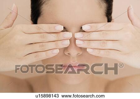 Young woman with hand over her mouth, see no evil View Large Photo Image Stock Image - Young woman with hand over her mouth, see no evil. Fotosearch