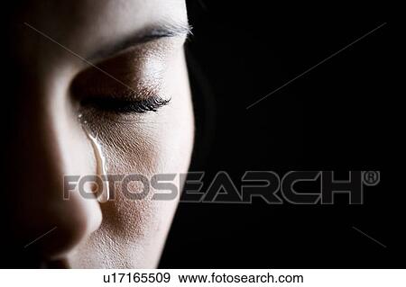 Stock Photo - Close up of woman crying. Fotosearch