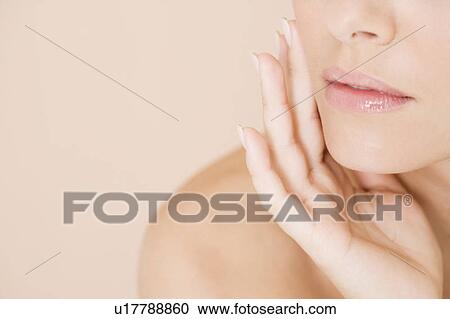 Close-up of woman holding her hand to her face View Large Photo Image Stock Image - Close-up of woman holding her hand to her face. Fotosearch