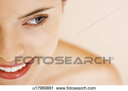 Stock Image - Close-up portrait of young woman, smiling. Fotosearch