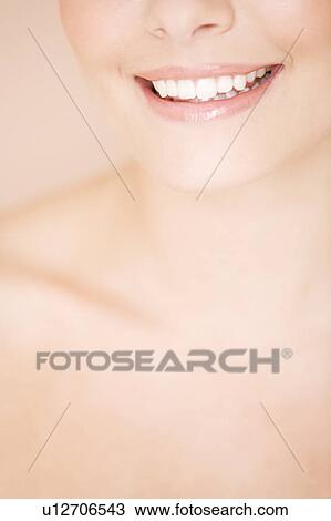Cropped portrait of a young woman smiling View Large Photo Image Stock Image - Cropped portrait of a young woman smiling. Fotosearch