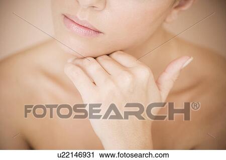 Detail of young woman's face, holding her hand to her chin View Large Photo Image Stock Image - Detail of young woman's face, holding her hand to her chin. Fotosearch