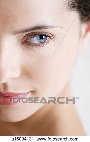 Stock Image - Left side of a young woman's face. Fotosearch