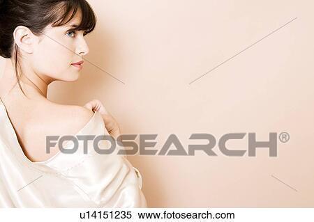 Elegant young woman in a white silk dress or wrap View Large Photo Image Stock Photography - Elegant young woman in a white silk dress or wrap. Fotosearch