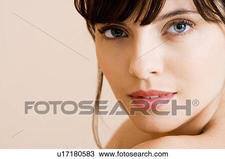 Portrait of young woman with brown hair looking over her shoulder View Large Photo Image Stock Image - Portrait of young woman with brown hair looking over her shoulder. Fotosearch