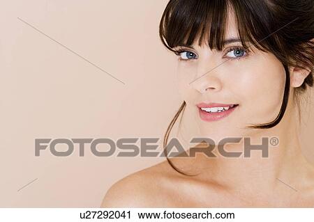 Portrait of young woman with brown hair, smiling View Large Photo Image Stock Image - Portrait of young woman with brown hair, smiling. Fotosearch