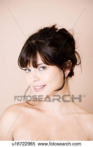 Portrait of young woman with brown hair, smiling View Large Photo Image Stock Photography - Portrait of young woman with brown hair, smiling. Fotosearch