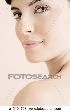 Young woman looking over her shoulder View Large Photo Image Stock Image - Young woman looking over her shoulder. Fotosearch