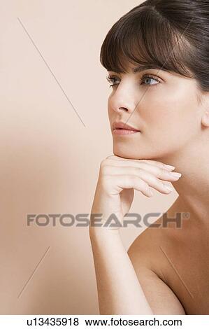 Young woman looking pensive, thinking View Large Photo Image Stock Photo - Young woman looking pensive, thinking. Fotosearch