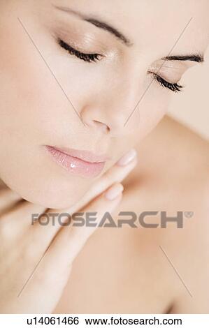 Stock Photograph - Close-up of young woman's face, eyes closed. Fotosearch