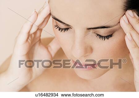Portrait of young woman with eyes closed and fingers on her temples, concentrating View Large Photo Image Picture - Portrait of young woman with eyes closed and fingers on her temples, concentrating. Fotosearch