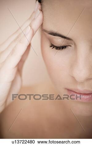 Portrait of young woman with eyes closed and fingers on her temples, concentrating View Large Photo Image Stock Image - Portrait of young woman with eyes closed and fingers on her temples, concentrating. Fotosearch
