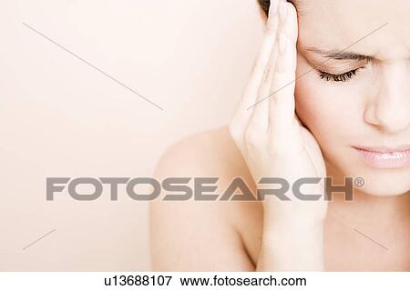Portrait of young woman with eyes closed and fingers on her temple, headache View Large Photo Image Stock Photo - Portrait of young woman with eyes closed and fingers on her temple, headache. Fotosearch