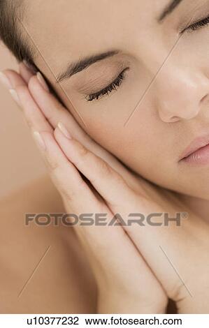 Woman asleep, resting her head on her hands View Large Photo Image Stock Image - Woman asleep, resting her head on her hands. Fotosearch