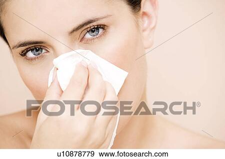 Woman blowing her nose View Large Photo Image Stock Photo - Woman blowing her nose. Fotosearch