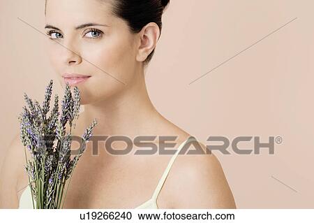 Stock Image - Woman holding a bunch of dried lavender. Fotosearch