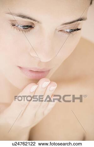Stock Image - Young woman blowing a kiss. Fotosearch