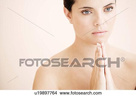 Young woman praying or meditating, hands together View Large Photo Image Picture - Young woman praying or meditating, hands together. Fotosearch
