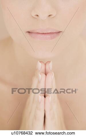Young woman praying or meditating, hands together View Large Photo Image Stock Image - Young woman praying or meditating, hands together. Fotosearch