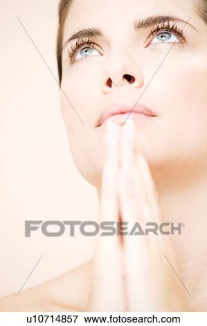 Young woman praying or meditating, hands together View Large Photo Image Stock Photo - Young woman praying or meditating, hands together. Fotosearch