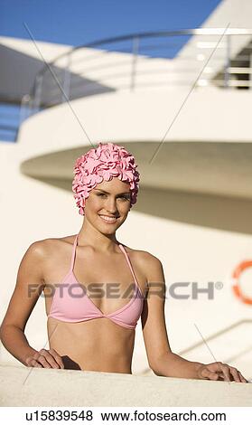Stock Photo - A woman in a bikini and swimming hat. Fotosearch