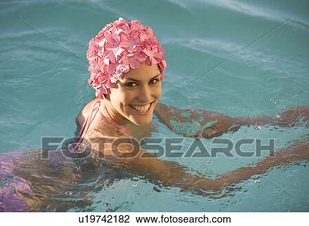 Stock Image - A woman in a swimming hat in a pool. Fotosearch