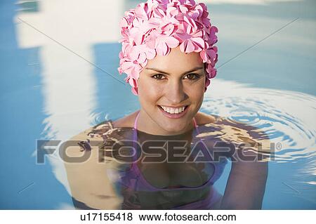 Stock Photo - A woman in a swimming hat in a pool. Fotosearch