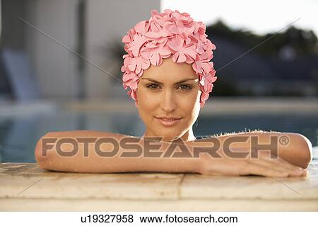 Stock Photo - A woman in a swimming hat in a pool. Fotosearch